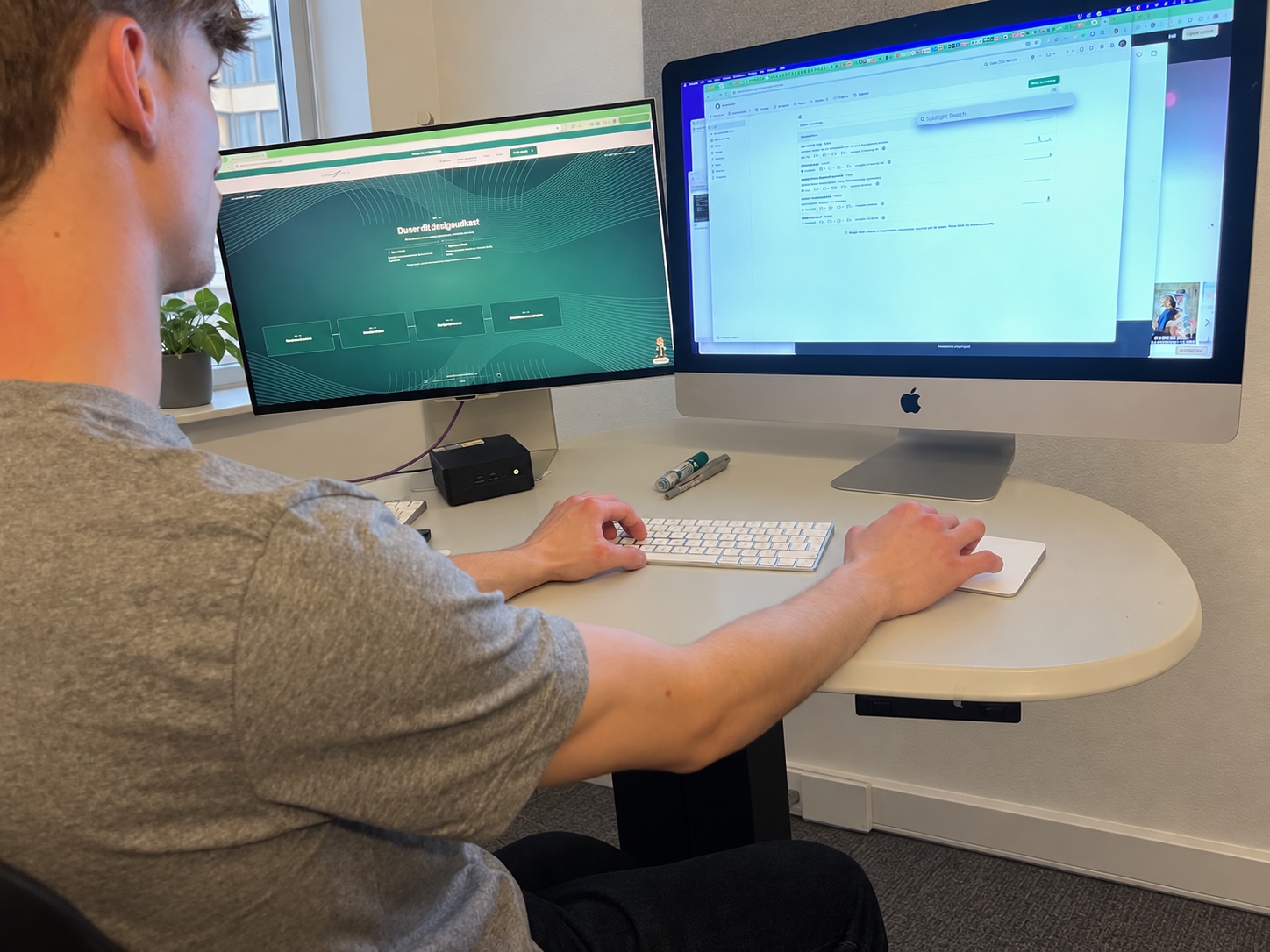 Working on the Stormbæk website at a desk with two screens